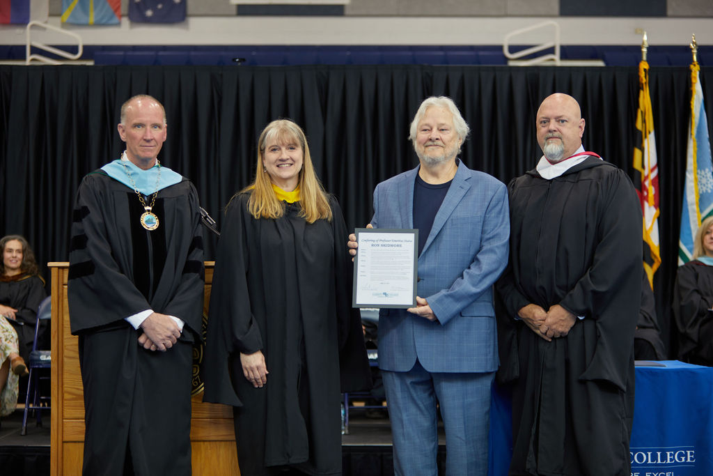 family of ron skidmore accepting emertius award